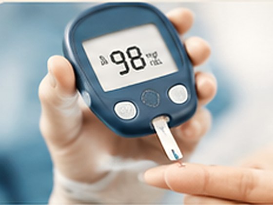 A glucometer reading a fingertip blood sugar sample